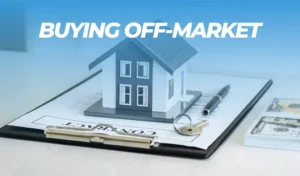 A small model of a house sits on a clipboard with a contract, next to a pen, a set of keys, and two stacks of hundred-dollar bills. At the top, the text "BUYING OFF-MARKET" highlights a lucrative opportunity at world of auctions.