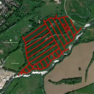 An aerial image shows a large, green area with a grid of red lines superimposed on it. The grid lines outline rectangular plots. Located near the Tonbridge Golf Centre and natural features such as Mill Stream is TN10 4LP, available for sale by auction with World of Auctions—a great piggy bank-style investment.
