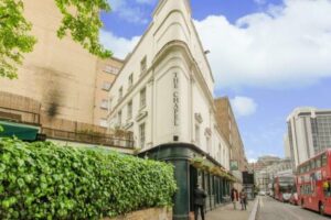 An advertisement image for a distressed hotel group for sale below market value in Central London, available through World of Auctions