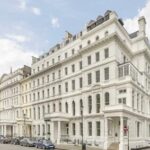 Grand, white-painted multi-story building with classic architectural details, located in Paddington, for sale by World of Auctions