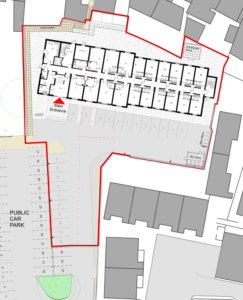 A building floor plan is highlighted in red, showing multiple rooms and corridors. The main entrance is labeled at the left side, with a ramp leading to it. Adjacent to the building is a parking area with labeled bays and a note indicating a bin store location.