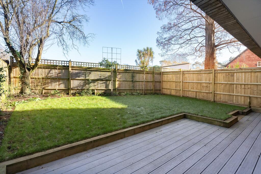 Property for sale by Auction A backyard with a wooden deck and grassy lawn bordered by a wooden fence gleams under the clear, sunny sky, perfect for hosting Wimbledon watch parties. A few bare trees and a small palm tree add charm to this inviting new home for sale. Presented by World of Auctions